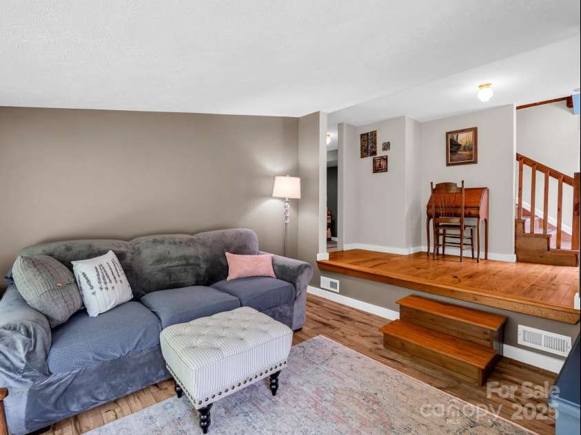 2430 2434 Mountain Page Road, Saluda, NC 28773.  MLS# CAR4276015, YatesRealty ID 26321. Family room is to the left of the entrance, bedroom, bathroom and laundry are down the hall on the left.  Stairs lead up to the main level