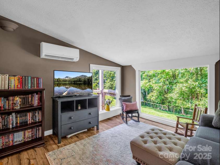 2430 2434 Mountain Page Road, Saluda, NC 28773.  MLS# CAR4276015, YatesRealty ID 26321. Family room overlooks the fenced pasture