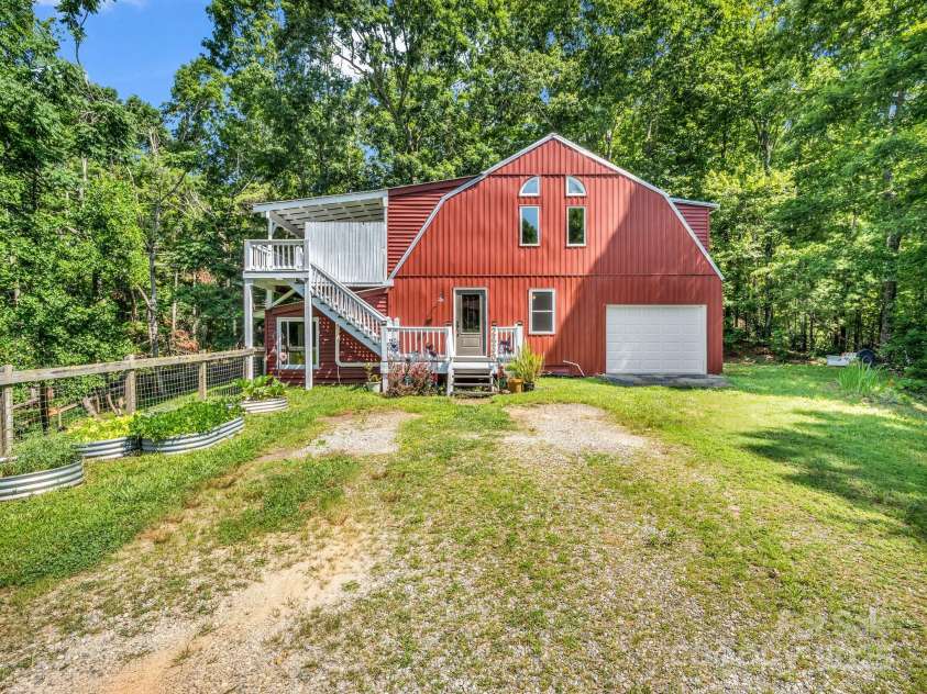 2430 2434 Mountain Page Road, Saluda, NC 28773.  MLS# CAR4276015, YatesRealty ID 26321. Garden area on the left along the pasture fence
