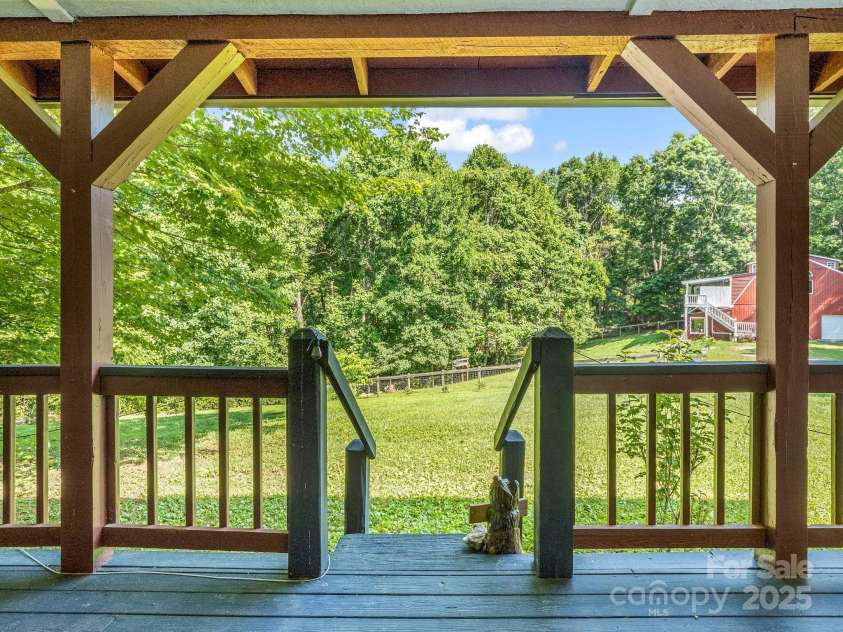 2430 2434 Mountain Page Road, Saluda, NC 28773.  MLS# CAR4276015, YatesRealty ID 26321. View of the pasture from the front porch at #2434