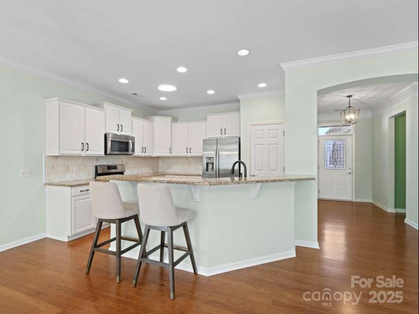 2035 Kennedy Drive, Indian Land, SC 29707.  MLS# CAR4278043, YatesRealty ID 26330. Kitchen with white cabinets and updated backsplash