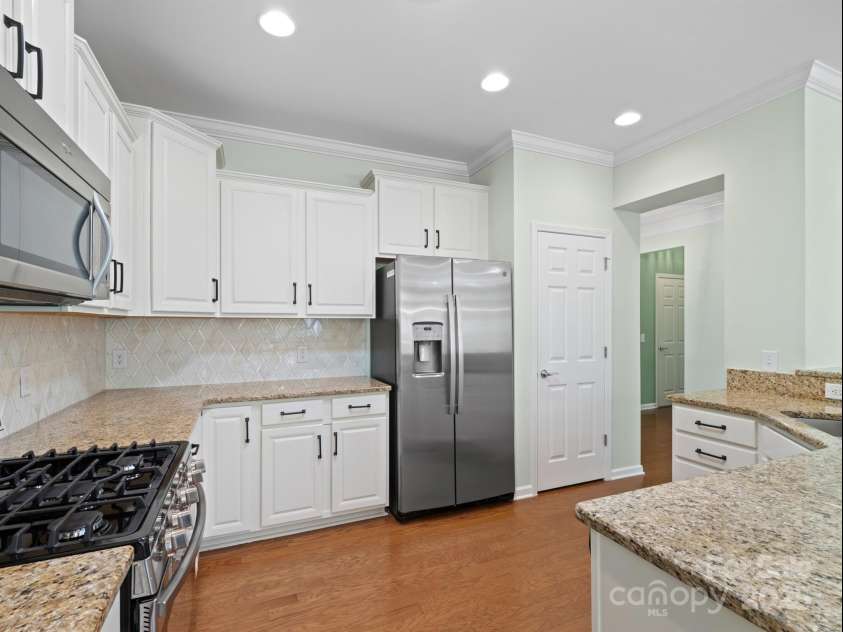 2035 Kennedy Drive, Indian Land, SC 29707.  MLS# CAR4278043, YatesRealty ID 26330. Kitchen with white cabinets and updated backsplash