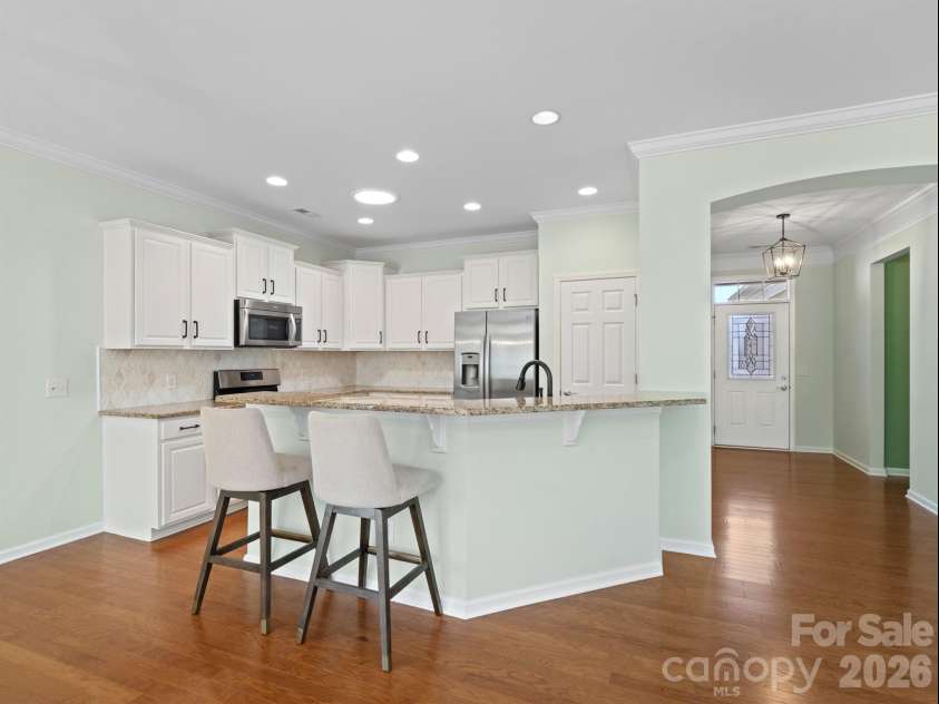 2035 Kennedy Drive, Indian Land, SC 29707.  MLS# CAR4278043, YatesRealty ID 26330. Kitchen with white cabinets and updated backsplash