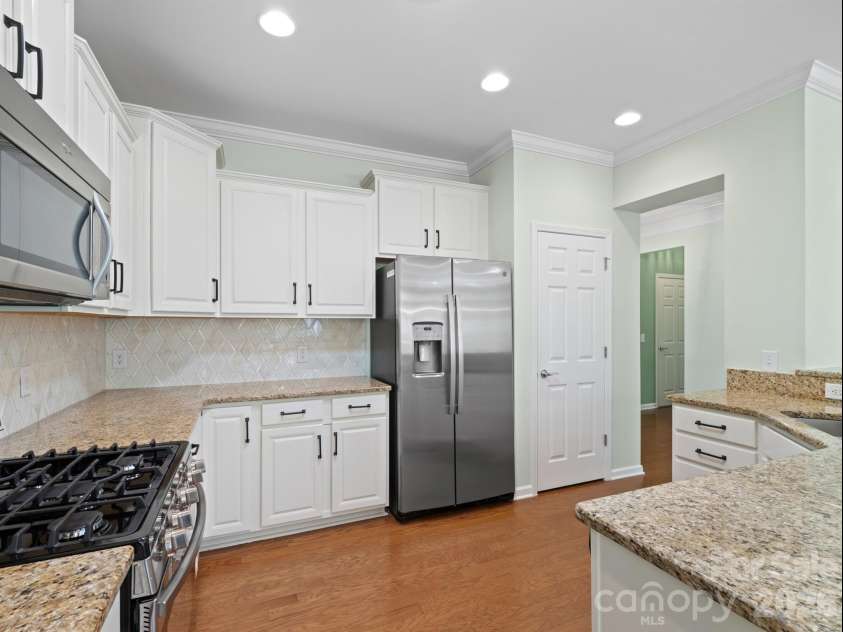 2035 Kennedy Drive, Indian Land, SC 29707.  MLS# CAR4278043, YatesRealty ID 26330. Kitchen with white cabinets and updated backsplash