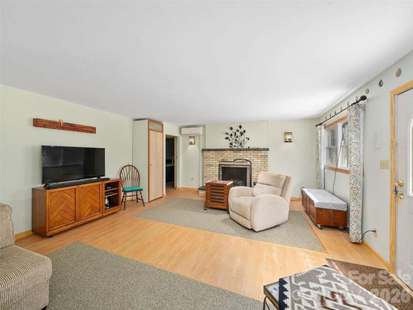 3829 Coxes Creek Road, Burnsville, NC 28714.  MLS# CAR4246043, YatesRealty ID 26331. Living room centers the split floor plan