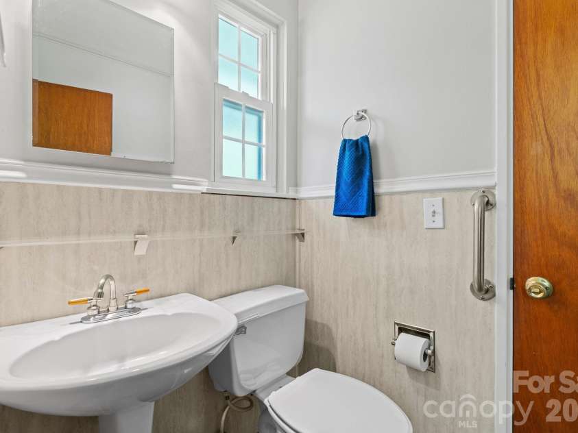 107 Appledore Avenue, Hendersonville, NC 28739.  MLS# CAR4379679, YatesRealty ID 26345. Half bath located between kitchen and guest bedroom/office.