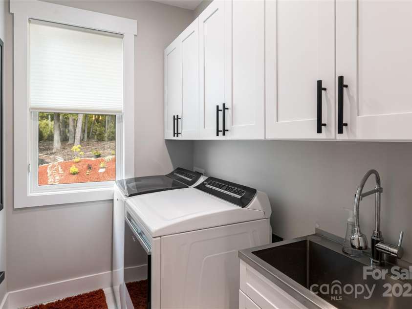 99 Timber Ridge Circle, Leicester, NC 28748.  MLS# CAR4261067, YatesRealty ID 26347. Spacious Laundry room with New stainless sink