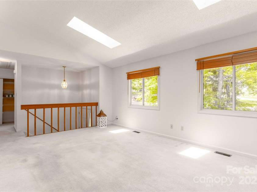 2 Oak Grove Road, Arden, NC 28704.  MLS# CAR4262932, YatesRealty ID 26361. Large, Bright Living Room with Nature Views and Skylights!