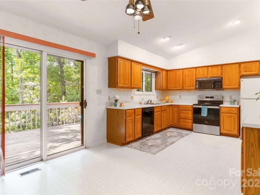 2 Oak Grove Road, Arden, NC 28704.  MLS# CAR4262932, YatesRealty ID 26361. Large Kitchen and Dining, with large Walk-out Deck!