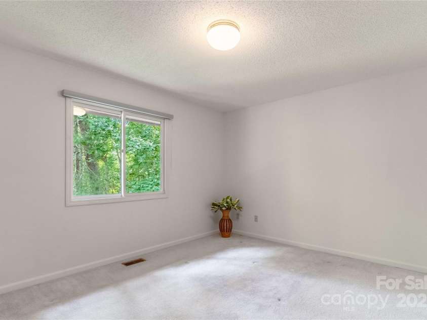 2 Oak Grove Road, Arden, NC 28704.  MLS# CAR4262932, YatesRealty ID 26361. Primary Bedroom- Nature Views!