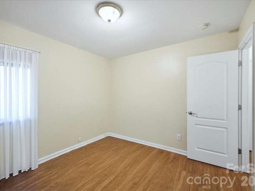 6552 Quarterbridge Lane, Charlotte, NC 28262.  MLS# CAR4386437, YatesRealty ID 26372. Bedroom #2 virtual empty
