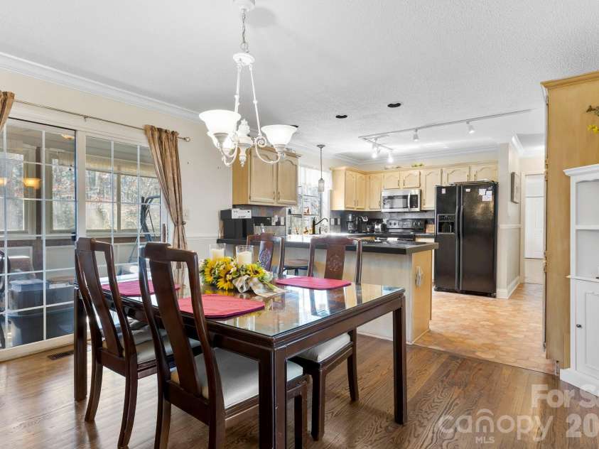 145 Fox Glen Drive, Arden, NC 28704.  MLS# CAR4134713, YatesRealty ID 26394. Dining room open to kitchen - wood floors