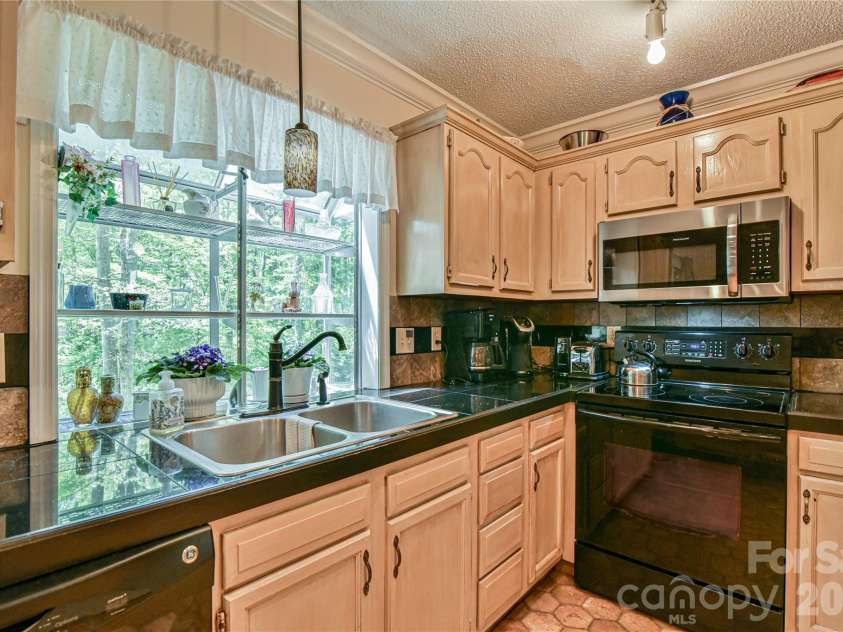 145 Fox Glen Drive, Arden, NC 28704.  MLS# CAR4134713, YatesRealty ID 26394. Kitchen garden box window to enjoy backyard views.
