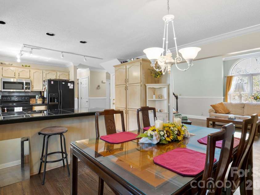 145 Fox Glen Drive, Arden, NC 28704.  MLS# CAR4134713, YatesRealty ID 26394. Living room flows into dining room & kitchen