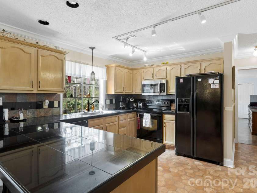 145 Fox Glen Drive, Arden, NC 28704.  MLS# CAR4134713, YatesRealty ID 26394. Main level kitchen with double pantry