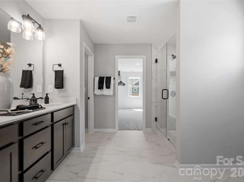 5081 Puddle Pond Road, Indian Trail, NC 28079.  MLS# CAR4386874, YatesRealty ID 26405. Representational photo *Model home*Primary bath