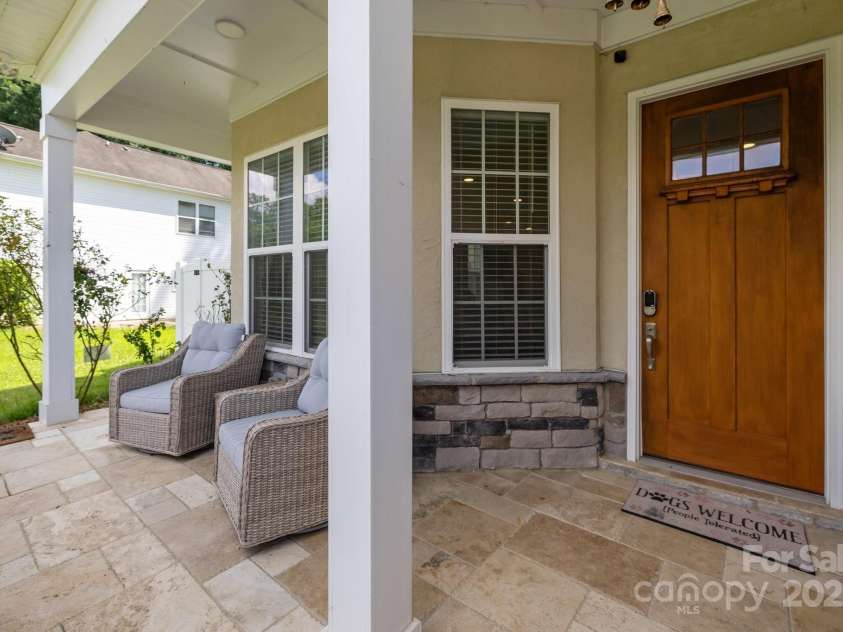 2117 Middlebridge Court, Fort Mill, SC 29715.  MLS# CAR4270419, YatesRealty ID 2642. Column stone wall and travertine tile front entrance.