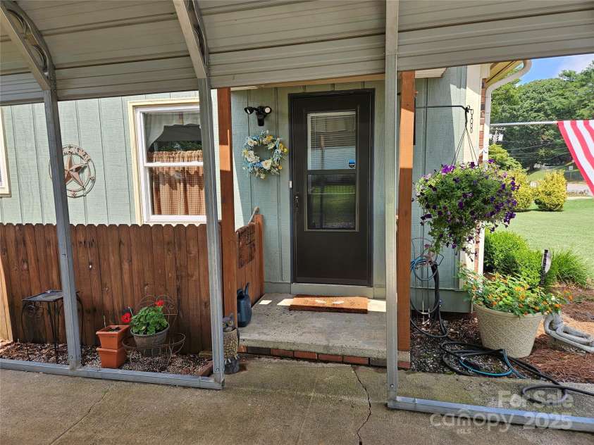 818 Laurel Street, Lincolnton, NC 28092.  MLS# CAR4282126, YatesRealty ID 26424. Side door at carport