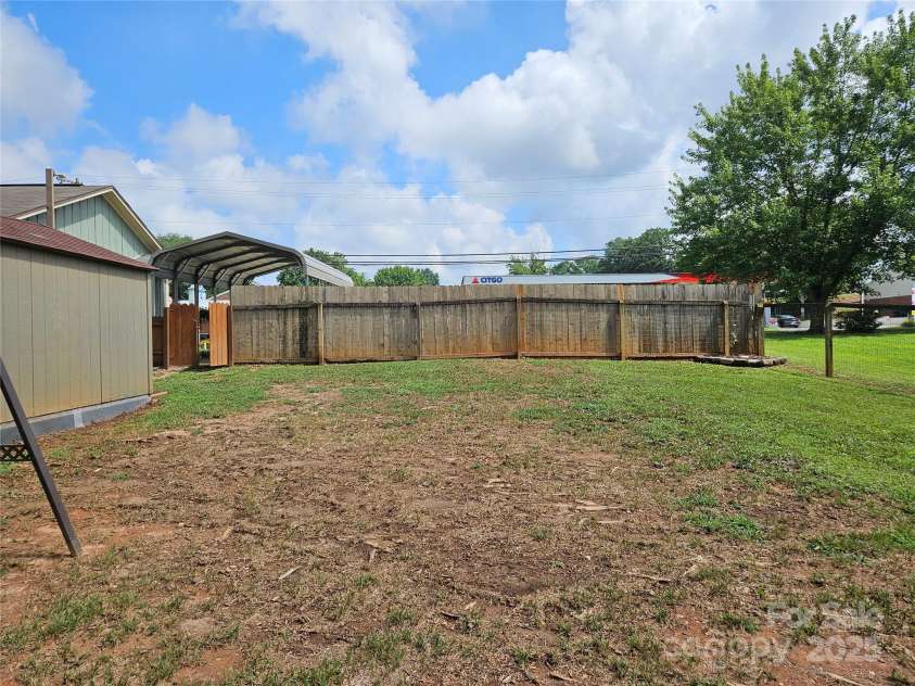 818 Laurel Street, Lincolnton, NC 28092.  MLS# CAR4282126, YatesRealty ID 26424. This part of back yard is completely fenced in. Privacy fencing along front of back yard.