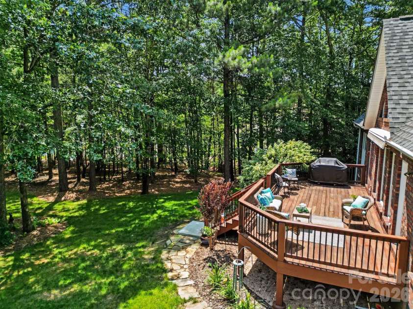 1233 Silver Arrow Court, Fort Mill, SC 29715.  MLS# CAR4386403, YatesRealty ID 26430. Deck overlooking the back yard and surrounded by trees