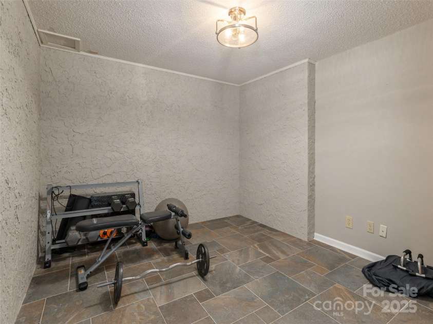 4 Silverstone Drive, Asheville, NC 28805.  MLS# CAR4280244, YatesRealty ID 26447. Lower Level Exercise Room