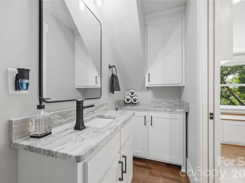 6355 Hickory Hill Lane, Stanfield, NC 28163.  MLS# CAR4381916, YatesRealty ID 26447. Second floor half bath with cabinet stoage