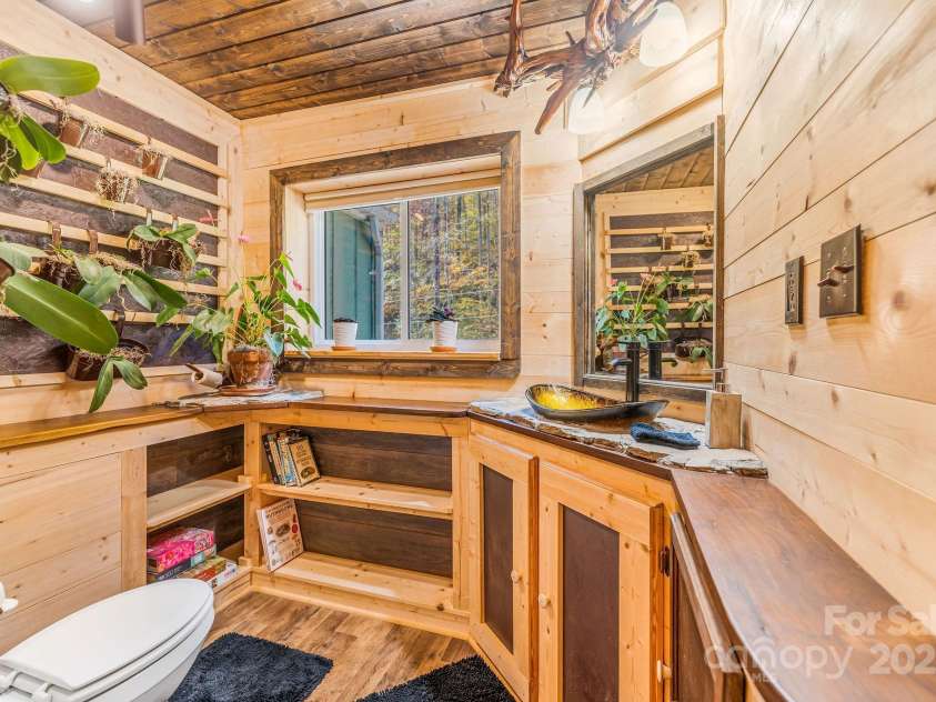 226 Fish Pond Lane, Burnsville, NC 28714.  MLS# CAR4326469, YatesRealty ID 2646. Custom bathroom features locally sourced wood framing a living plant wall.