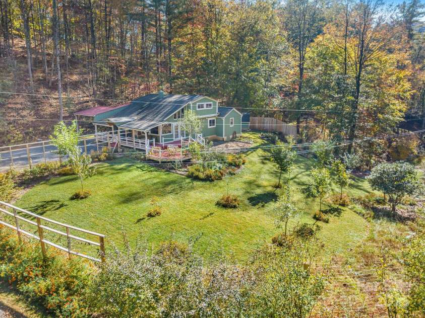 226 Fish Pond Lane, Burnsville, NC 28714.  MLS# CAR4326469, YatesRealty ID 2646. Edible landscape containing fruiting trees, veggies and herbs surrounded by 8 foot deer proof fencing.