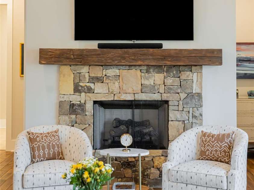 28 Woodland Aster Way, Asheville, NC 28804.  MLS# CAR4212425, YatesRealty ID 26479. Inviting stone fireplace w/reclaimed wood mantle.