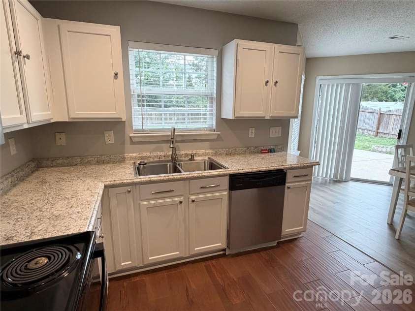 9233 Simonton Drive, Charlotte, NC 28269.  MLS# CAR4384205, YatesRealty ID 26481. Kitchen and rear exit