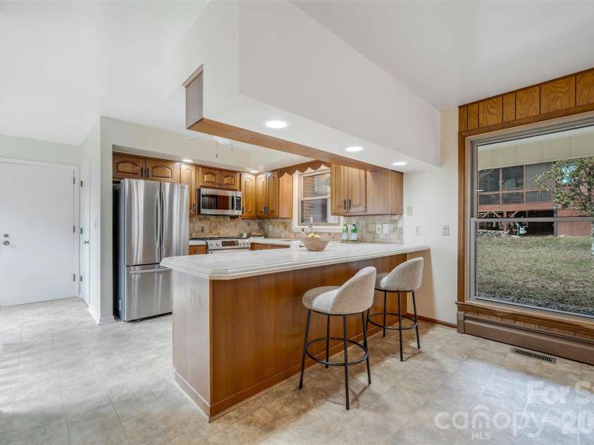 63 Pinecroft Road, Asheville, NC 28804.  MLS# CAR4352217, YatesRealty ID 26495. Kitchen with bar