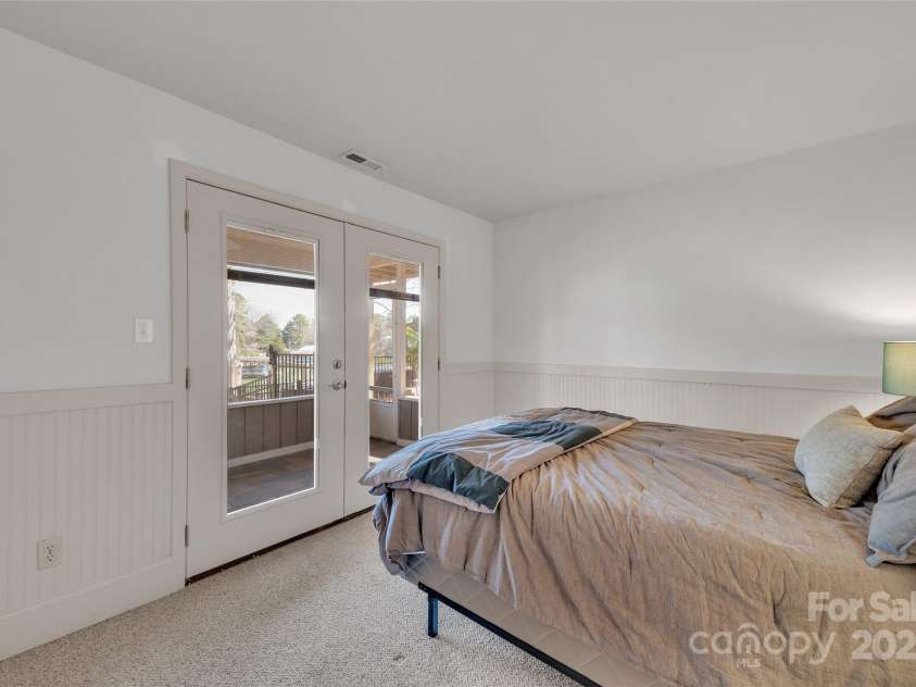 1077 Gauguin Lane, Tega Cay, SC 29708.  MLS# CAR4219217, YatesRealty ID 2651. Bedroom 2 with Lake View & Screen Porch