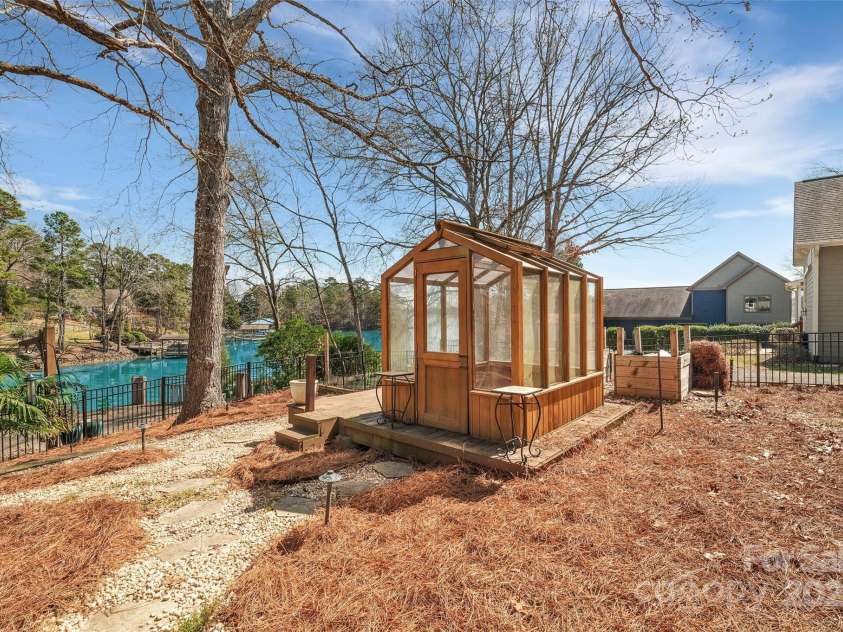 1077 Gauguin Lane, Tega Cay, SC 29708.  MLS# CAR4219217, YatesRealty ID 2651. Greenhouse with Lake View inside fenced yard
