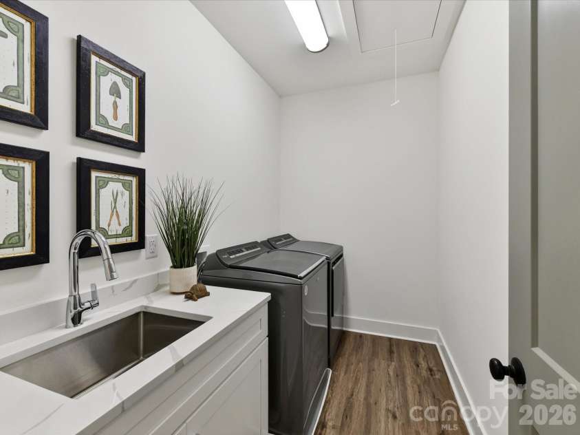 202 Streamwood Road, Troutman, NC 28166.  MLS# CAR4384366, YatesRealty ID 26520. Functional laundry room features built-in cabinetry, a utility sink, and ample space for storage and everyday convenience.