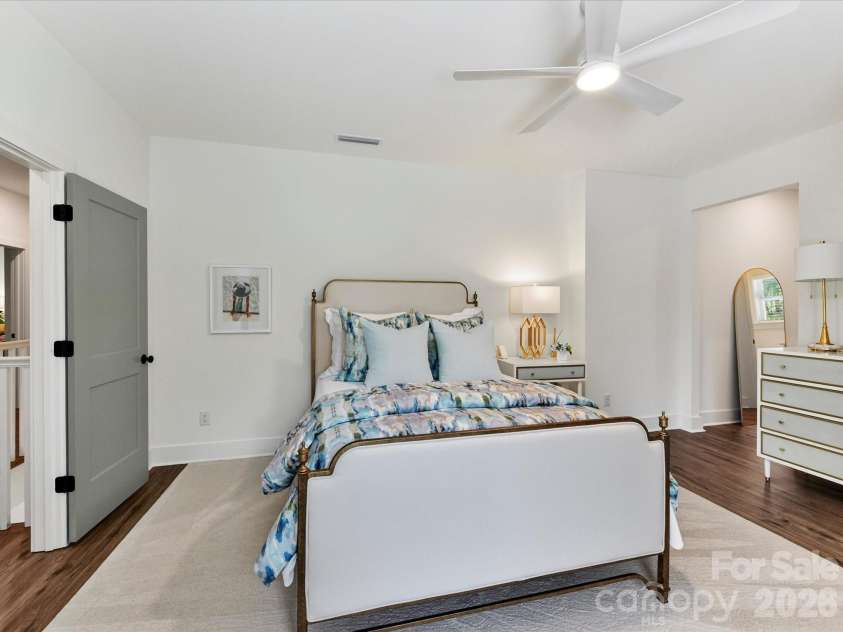 202 Streamwood Road, Troutman, NC 28166.  MLS# CAR4384366, YatesRealty ID 26520. Spacious secondary bedroom features a vaulted ceiling, neutral finishes, and ample room for guests, family, or a private retreat.