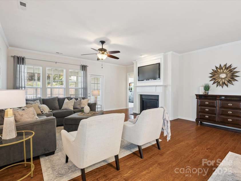 8036 Crater Lake Drive, Fort Mill, SC 29707.  MLS# CAR4271069, YatesRealty ID 26525. Great room features a gas fireplace and French door access to the screened porch