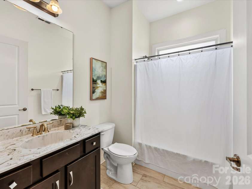 13003 Riley Grace Lane, Cornelius, NC 28031.  MLS# CAR4418120, YatesRealty ID 26526. Full bath features a spacious vanity with ample storage, decorative countertop, tub/shower combination, and natural light.