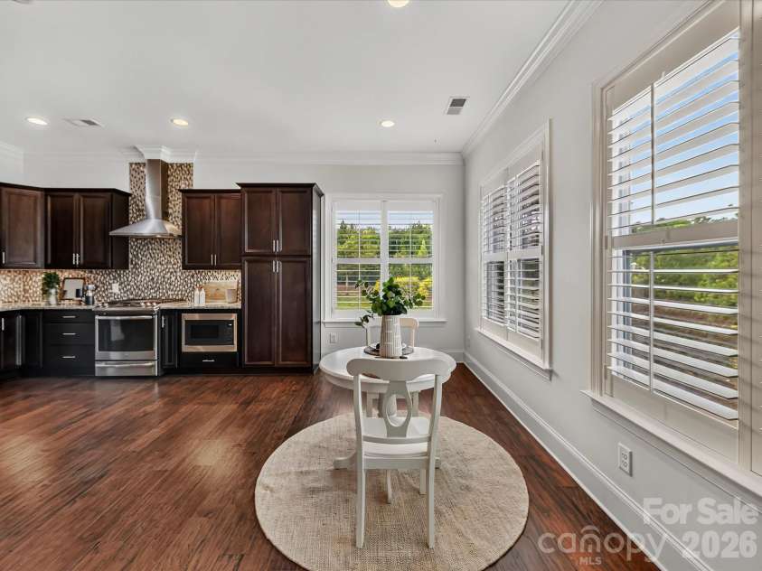 13003 Riley Grace Lane, Cornelius, NC 28031.  MLS# CAR4418120, YatesRealty ID 26526. Kitchen flows seamlessly into the bright breakfast nook, where abundant windows and open sightlines create an inviting space for casual dining.