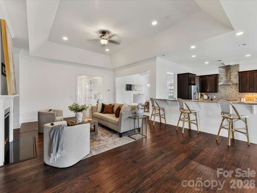13003 Riley Grace Lane, Cornelius, NC 28031.  MLS# CAR4418120, YatesRealty ID 26526. Open-concept Great Room and kitchen feature soaring ceilings, a cozy gas log fireplace, and an expansive breakfast bar that creates an effortless flow for everyday living and entertaining.