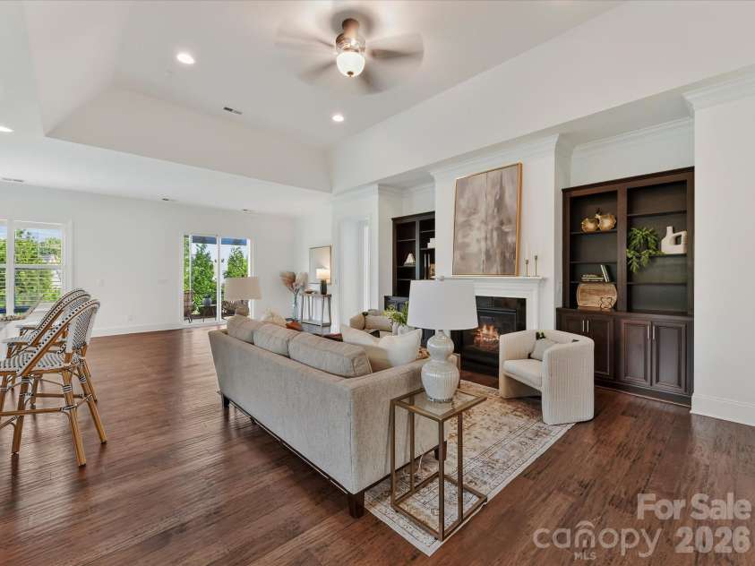 13003 Riley Grace Lane, Cornelius, NC 28031.  MLS# CAR4418120, YatesRealty ID 26526. Spacious Great Room features a tray ceiling, cozy gas log fireplace flanked by built-in cabinetry, and an open layout ideal for everyday living and entertaining.