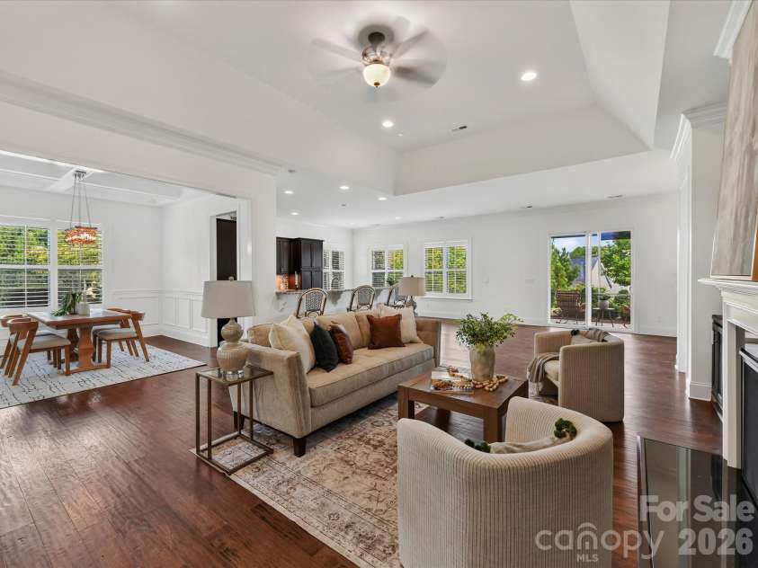 13003 Riley Grace Lane, Cornelius, NC 28031.  MLS# CAR4418120, YatesRealty ID 26526. Spacious Great Room features a tray ceiling, cozy gas log fireplace flanked by built-in cabinetry, and an open layout ideal for everyday living and entertaining.