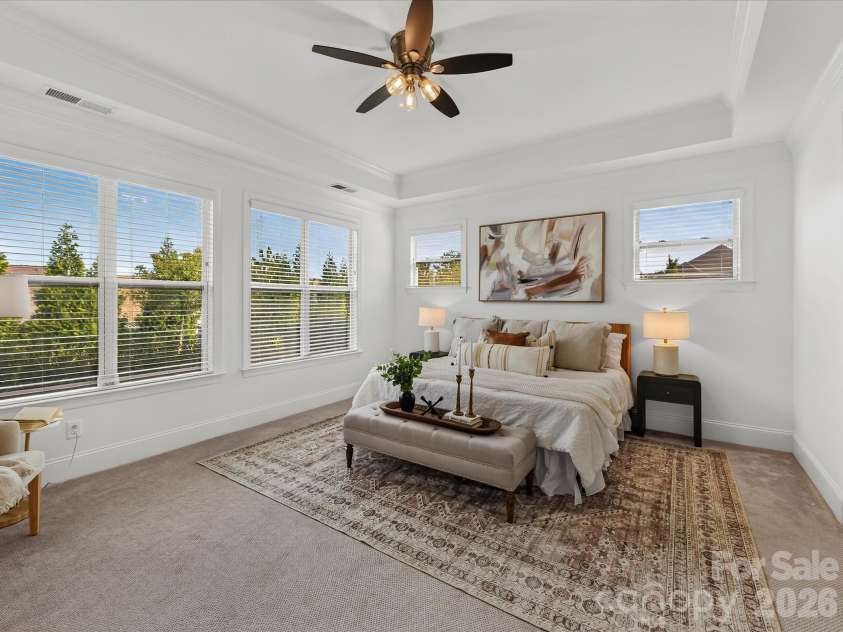 13003 Riley Grace Lane, Cornelius, NC 28031.  MLS# CAR4418120, YatesRealty ID 26526. Spacious primary suite features a deep tray ceiling, abundant natural light, and a serene layout offering a comfortable private retreat.