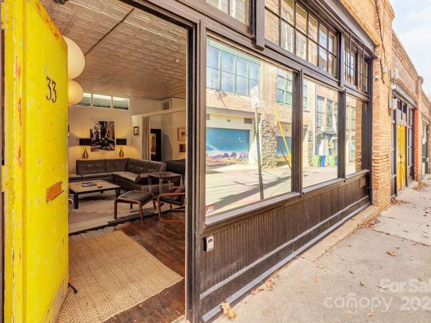 33 Carolina Lane, Asheville, NC 28801.  MLS# CAR4277865, YatesRealty ID 26531. Greeted by a steel door and one way glass for privacy from the Lane.