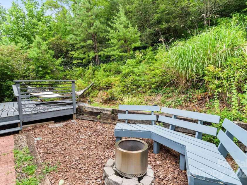 32 Tucker Road, Black Mountain, NC 28711.  MLS# CAR4275444, YatesRealty ID 26535. Built in seating & firepit - perfect for fall!