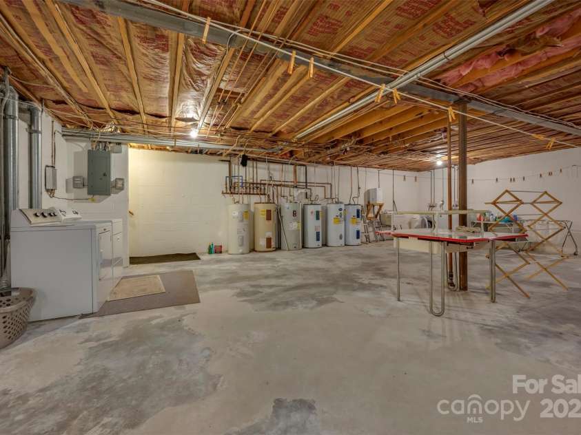 305 Grady Avenue, Tryon, NC 28782.  MLS# CAR4233461, YatesRealty ID 2654. Basement Laundry and Storage