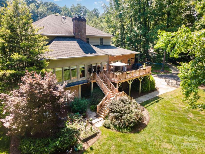408 Johnsfield Road, Shelby, NC 28150.  MLS# CAR4269402, YatesRealty ID 26543. Stairs from the deck lead to the back yard for easy access