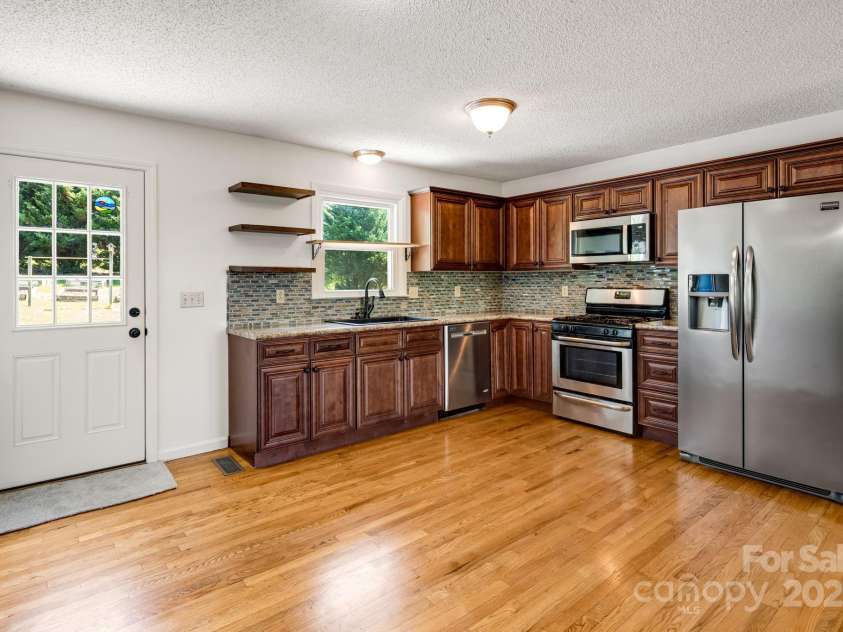 1360 Jupiter Road, Weaverville, NC 28787.  MLS# CAR4276296, YatesRealty ID 26556. Open Living Room and Kitchen Main Floor