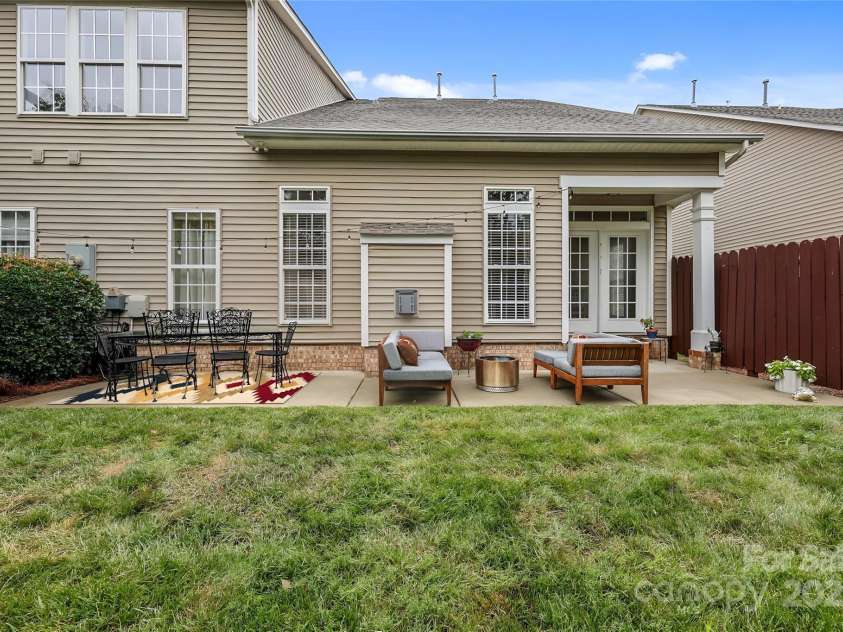 10217 Linksland Drive, Huntersville, NC 28078.  MLS# CAR4281355, YatesRealty ID 26573. From the back of the property, you can enjoy a clear view of the inviting patio, perfect for relaxing or entertaining while enjoying the outdoor scenery.