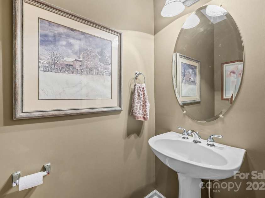 10217 Linksland Drive, Huntersville, NC 28078.  MLS# CAR4281355, YatesRealty ID 26573. Half bath on main floor features a pedestal sink.