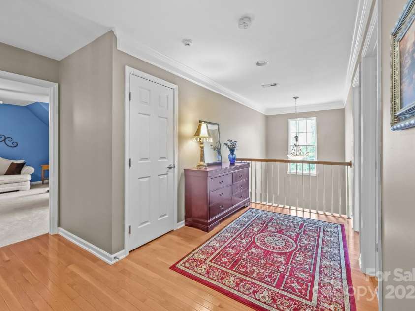 10217 Linksland Drive, Huntersville, NC 28078.  MLS# CAR4281355, YatesRealty ID 26573. Loft overlooks the home’s entrance and foyer, creating a welcoming vantage point that adds to the open, connected feel of the space